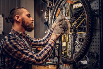 person servicing bike